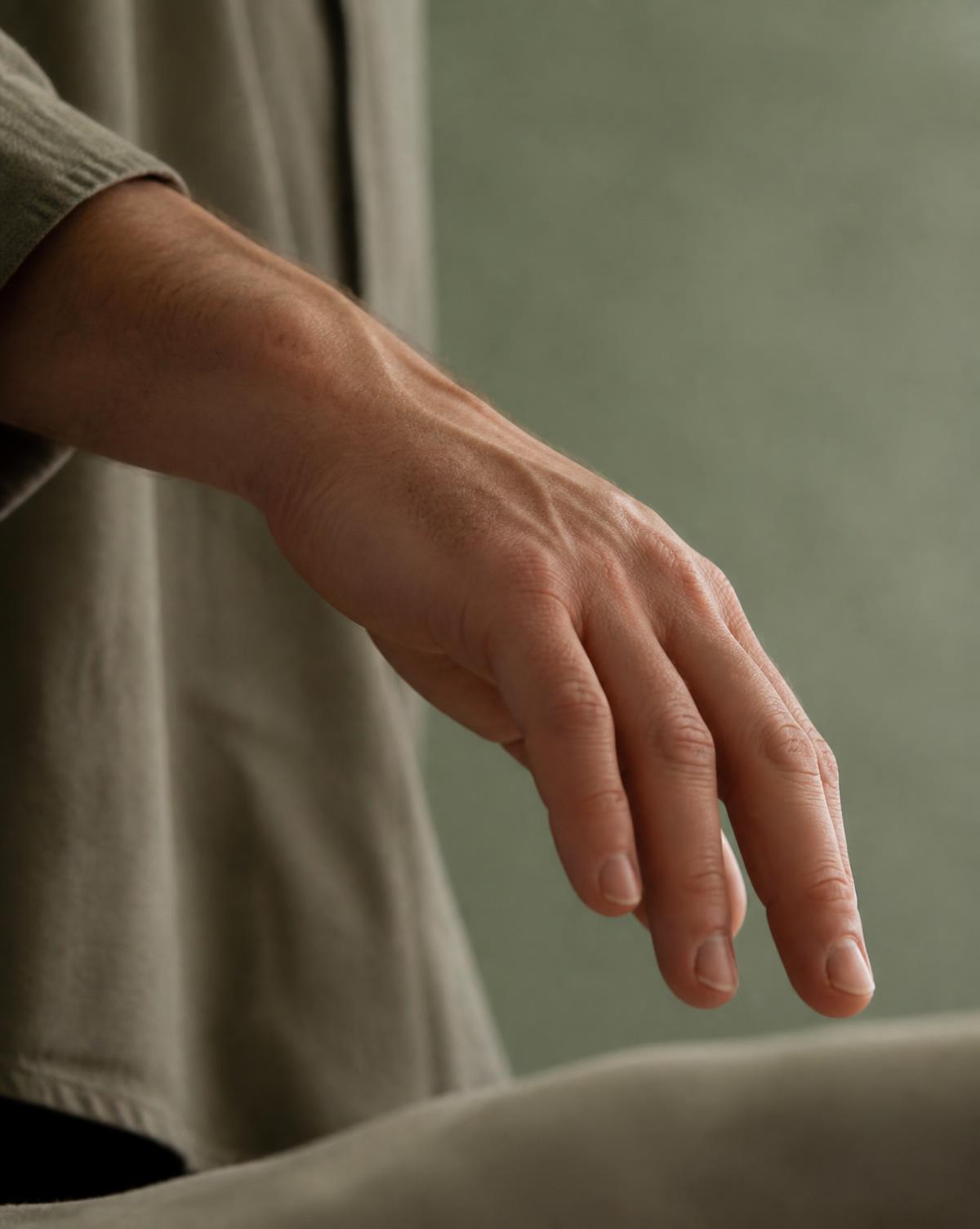 A hand moving slowly in soft daylight